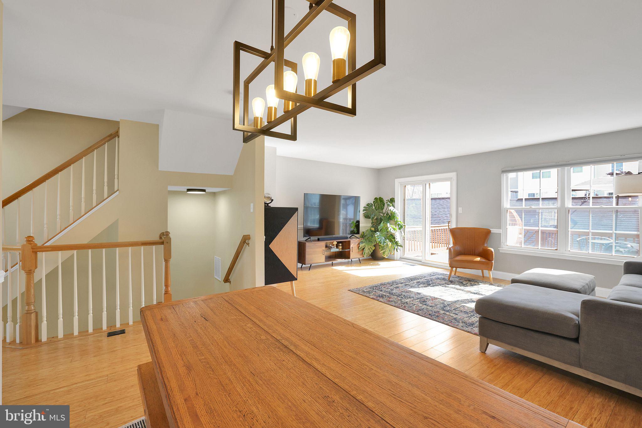 22952 Regent Terrace Sterling, VA 20166 - Photo 12 of 64 a bedroom with a bed a chandelier and balcony view