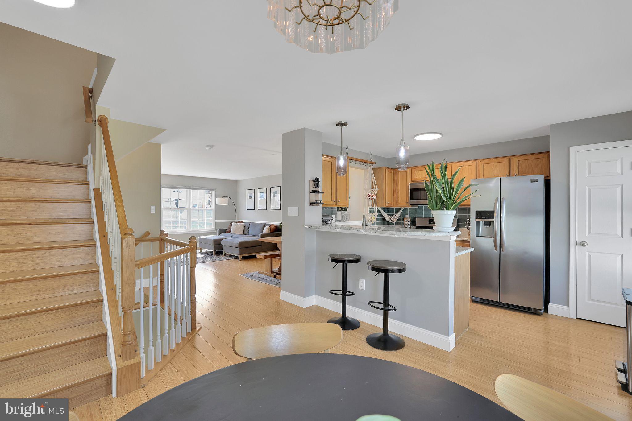 22952 Regent Terrace Sterling, VA 20166 - Photo 20 of 64 a view of living room with furniture and a kitchen view