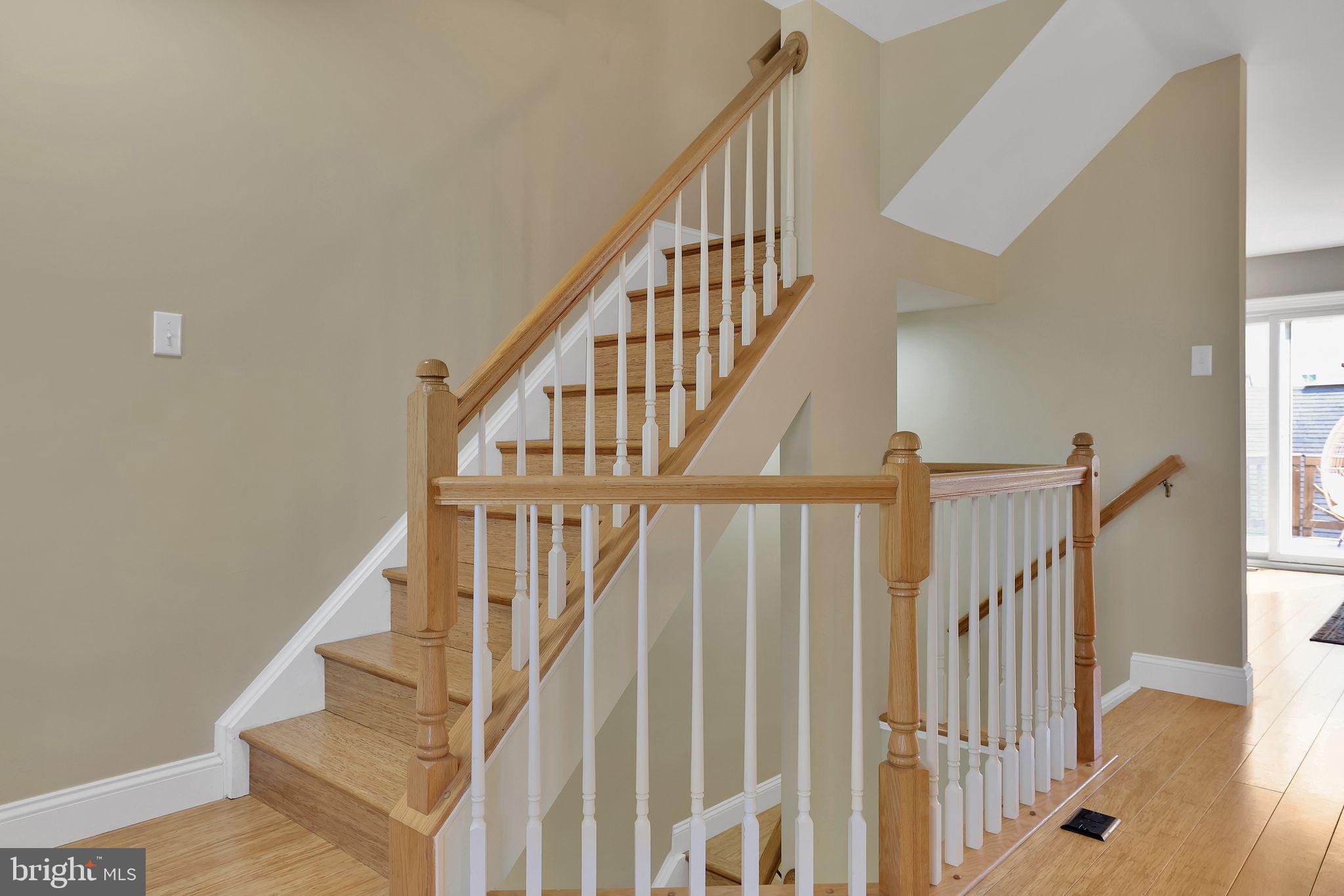 22952 Regent Terrace Sterling, VA 20166 - Photo 22 of 64 a view of staircase with wooden floor and white walls