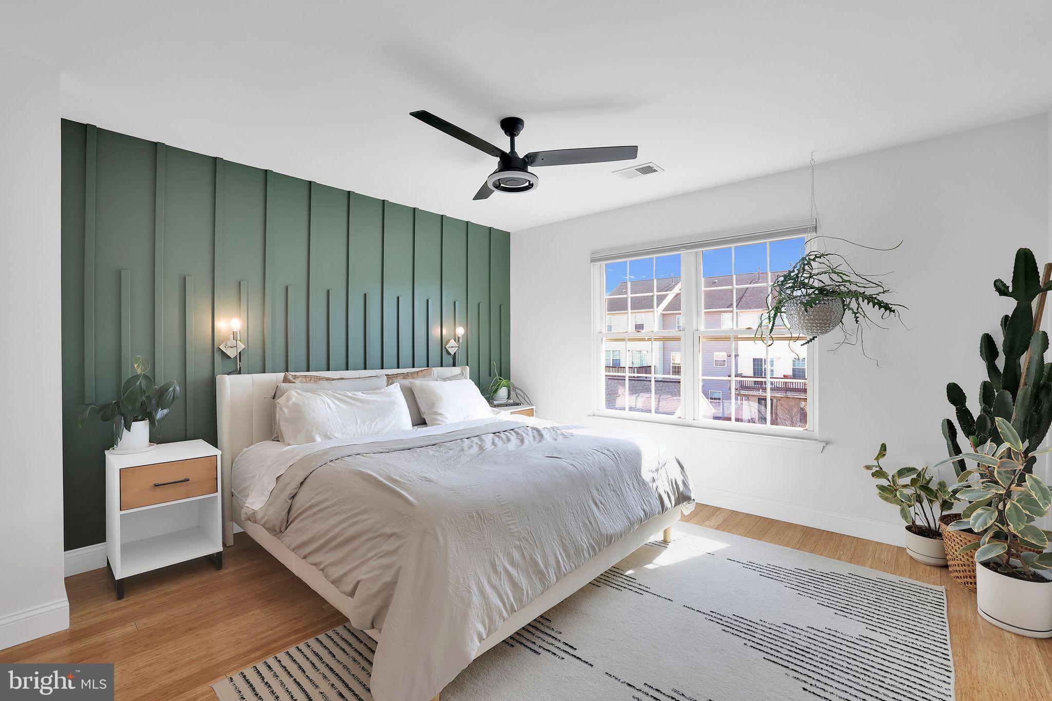 22952 Regent Terrace Sterling, VA 20166 - Photo 23 of 64 a bedroom with a large bed chandelier and a window