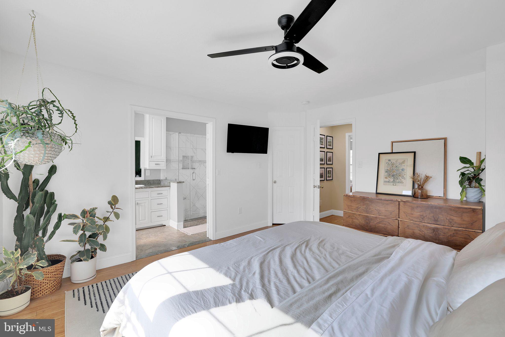 22952 Regent Terrace Sterling, VA 20166 - Photo 26 of 64 a bedroom with a large bed and a flat screen tv