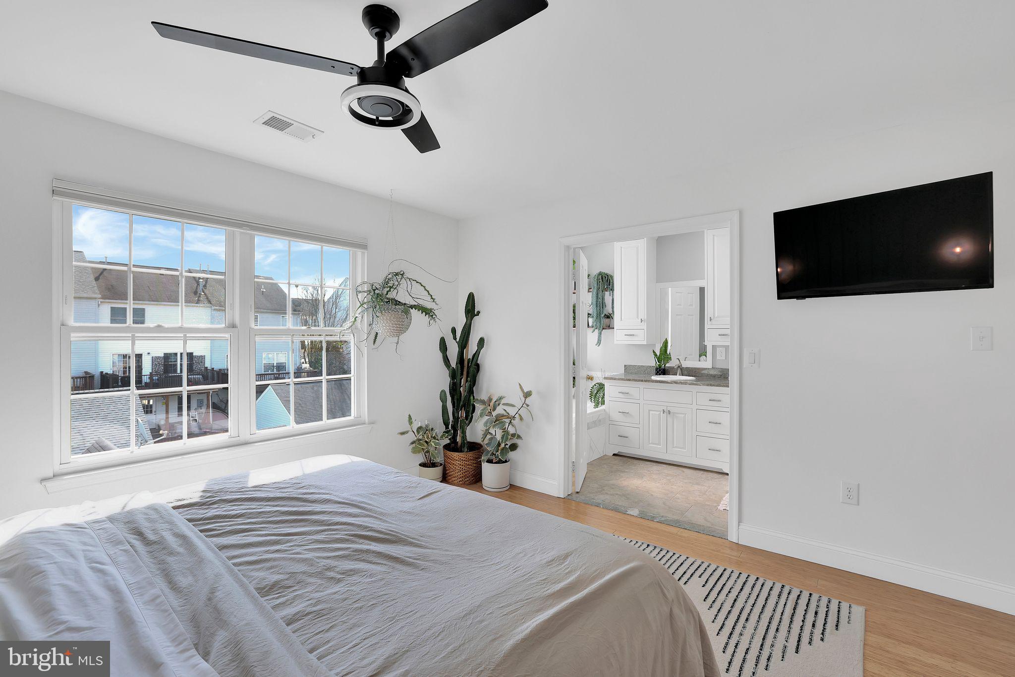 22952 Regent Terrace Sterling, VA 20166 - Photo 27 of 64 a bedroom with a bed and a flat screen tv