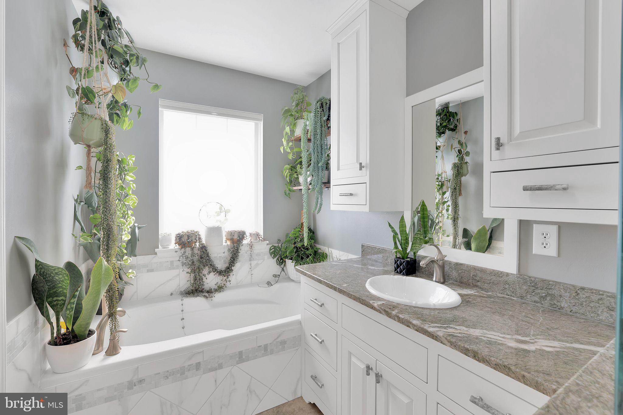 22952 Regent Terrace Sterling, VA 20166 - Photo 29 of 64 a bath room with a granite countertop sink and a mirror