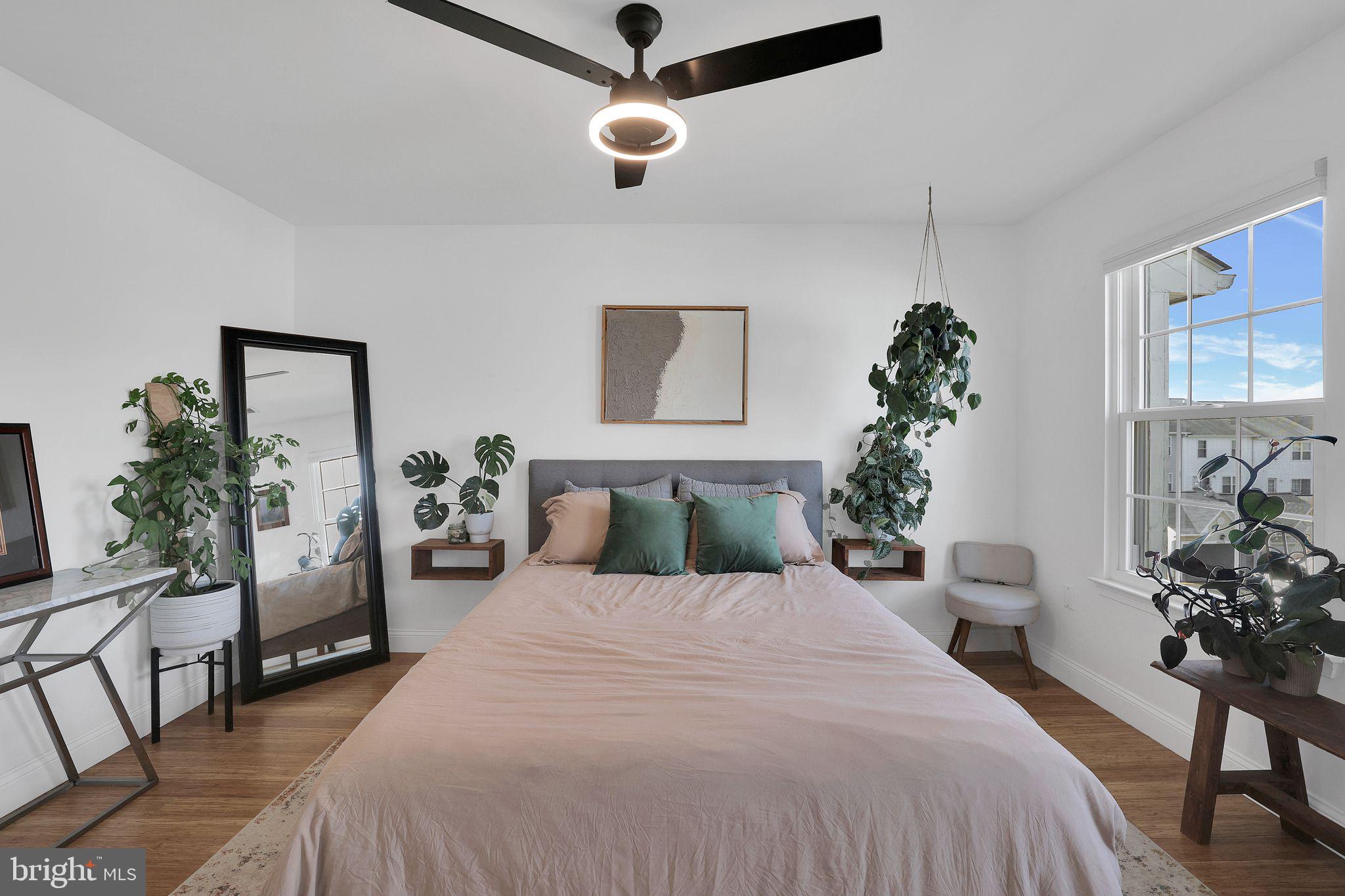 22952 Regent Terrace Sterling, VA 20166 - Photo 32 of 64 a bedroom with a large bed and a chandelier