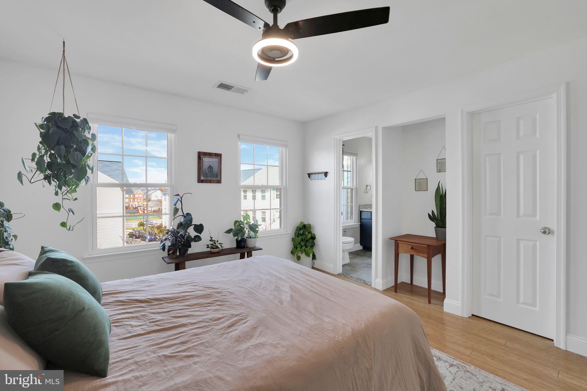22952 Regent Terrace Sterling, VA 20166 - Photo 35 of 64 a bedroom with a bed and a chandelier