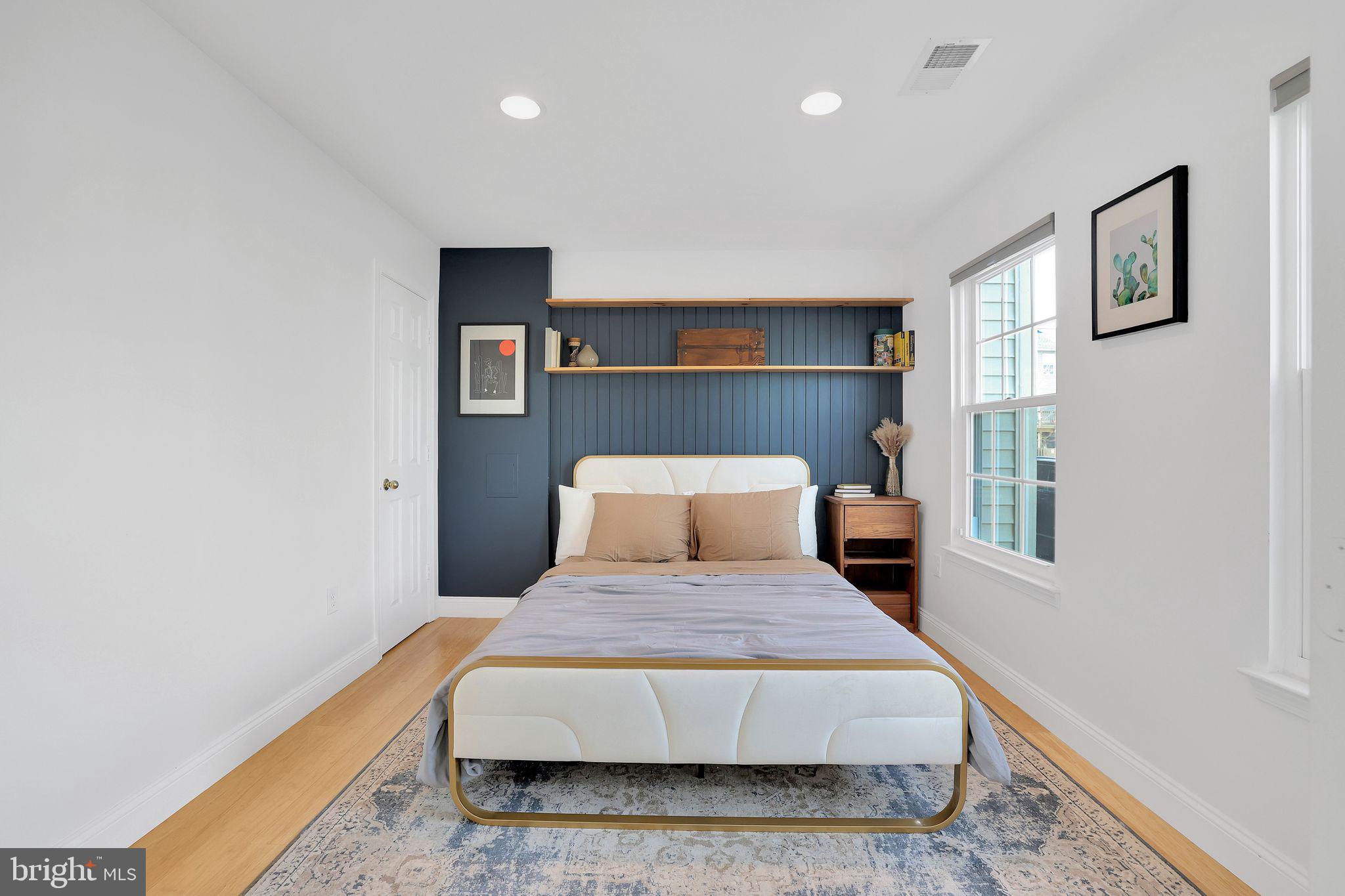 22952 Regent Terrace Sterling, VA 20166 - Photo 40 of 64 a bedroom with a large bed and a chandelier