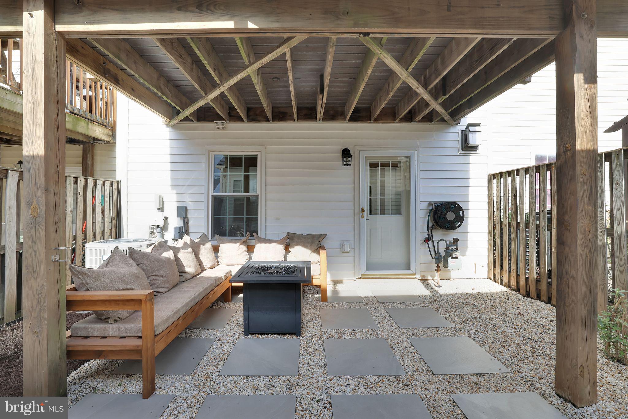 22952 Regent Terrace Sterling, VA 20166 - Photo 50 of 64 a outdoor space with patio the couches and a dining table with garden view