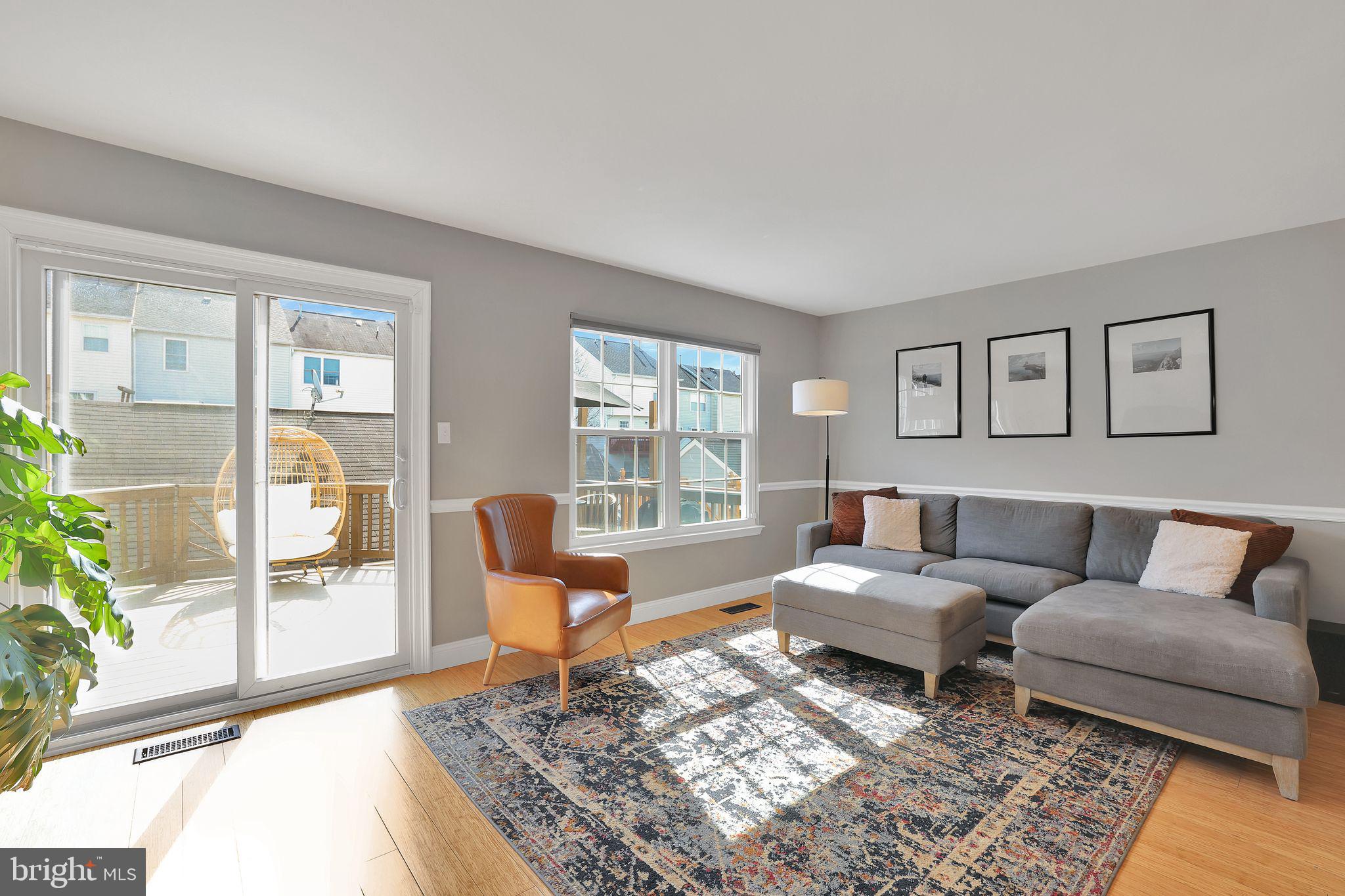 22952 Regent Terrace Sterling, VA 20166 - Photo 5 of 64 a living room with furniture and a floor to ceiling window