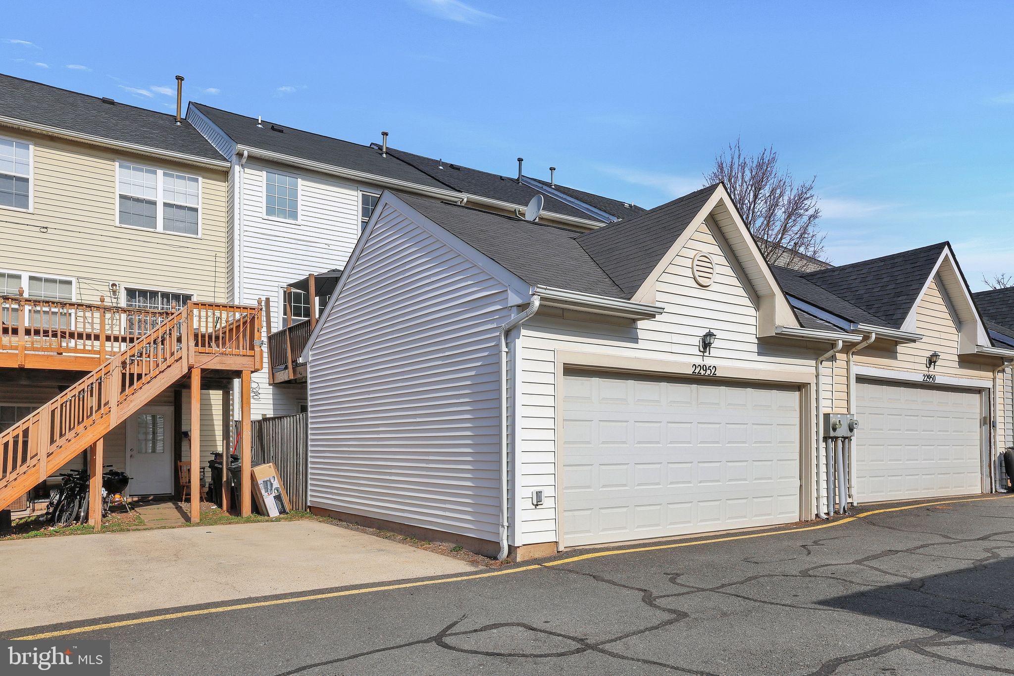 22952 Regent Terrace Sterling, VA 20166 - Photo 57 of 64 a view of house with wooden stairs and a large tree