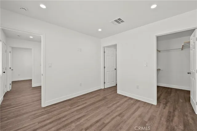 a view of hallway with wooden floor