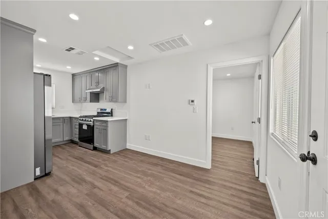 a view of kitchen with stainless steel appliances a refrigerator and a stove top oven