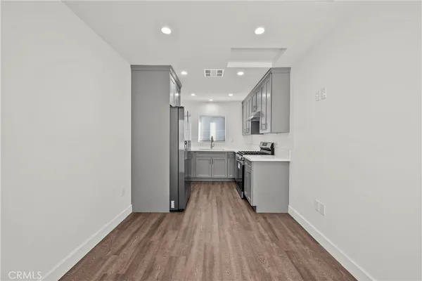 a view of a kitchen with a sink and a stove top oven
