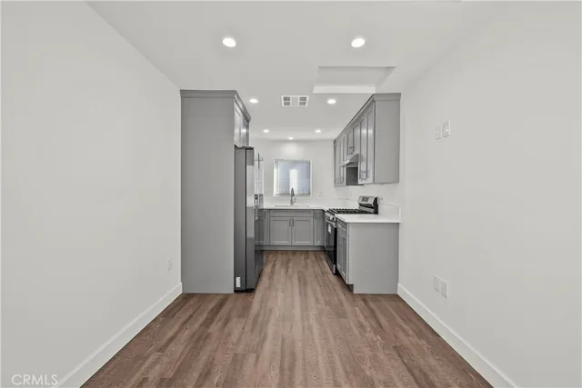 a view of a kitchen with a sink and a stove top oven
