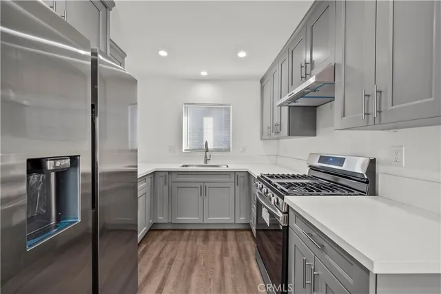 a kitchen with a sink stove and refrigerator