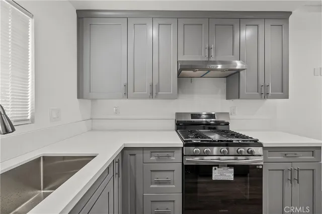 a kitchen with stainless steel appliances granite countertop a stove and a sink