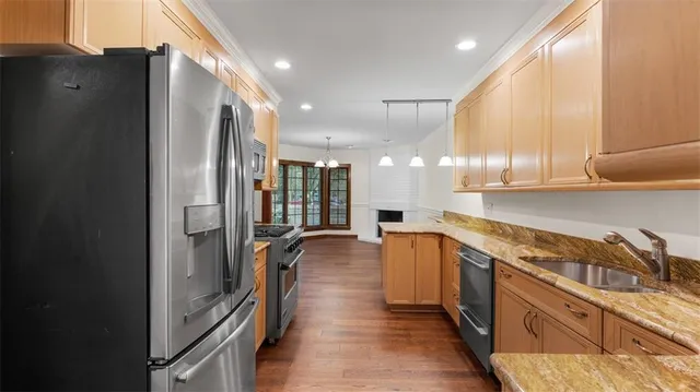 a kitchen with stainless steel appliances a refrigerator and a sink