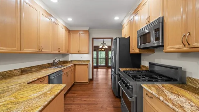 a kitchen with stainless steel appliances granite countertop a stove and a sink