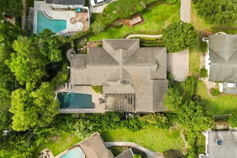 an aerial view of a house with garden space and street view