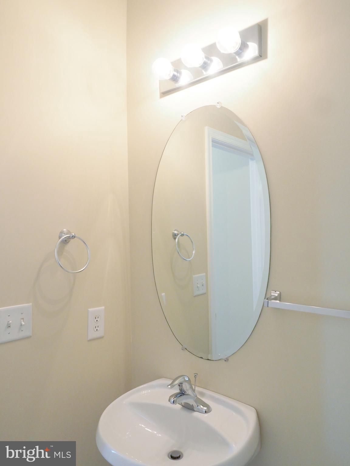 18 Solara Court Inwood, WV 25428 - Photo 11 of 24 a bathroom with a sink and mirror