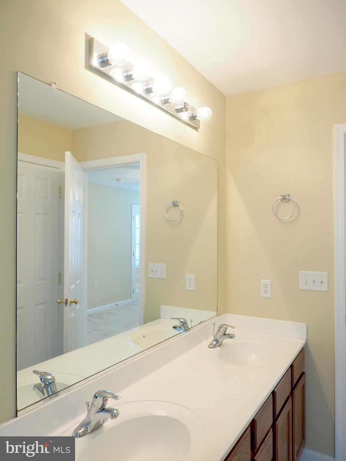 18 Solara Court Inwood, WV 25428 - Photo 15 of 24 a bathroom with a sink and a mirror