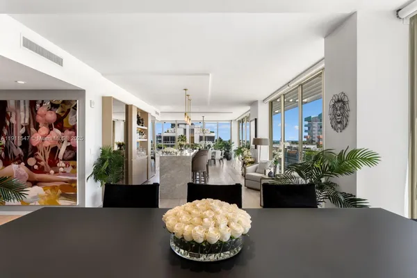 a living room with furniture and potted plant