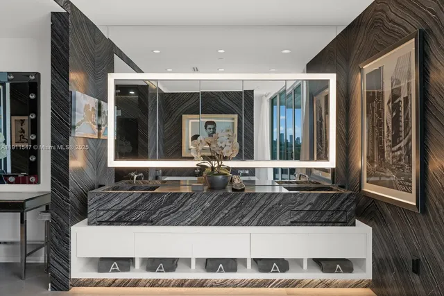 a bathroom with a bathtub and a painting on the wall