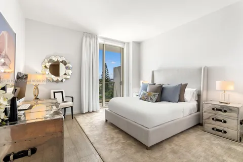 a spacious bedroom with a bed and glass door