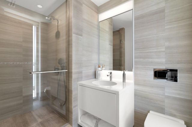 a spacious bedroom with a bed and glass window