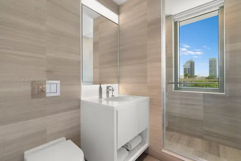 a hallway with furniture and a potted plant