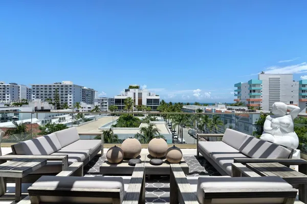 a view of a terrace with seating area and city view
