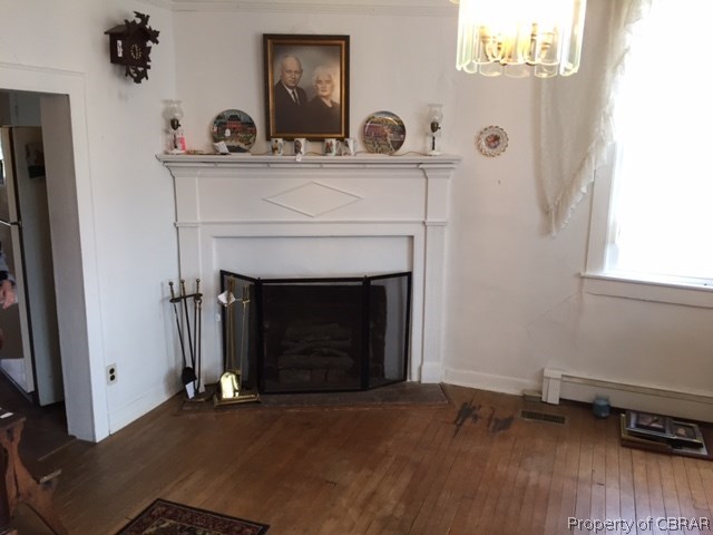 6019 Burleigh Road Gloucester, VA 23061 - Photo 11 of 12 Dining room with the narrow wood floors and a FP, this is just off the kitchen