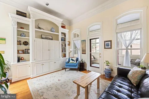 a bedroom with a bed furniture and a book shelf