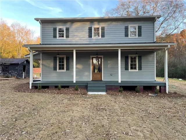 a house with trees in the background