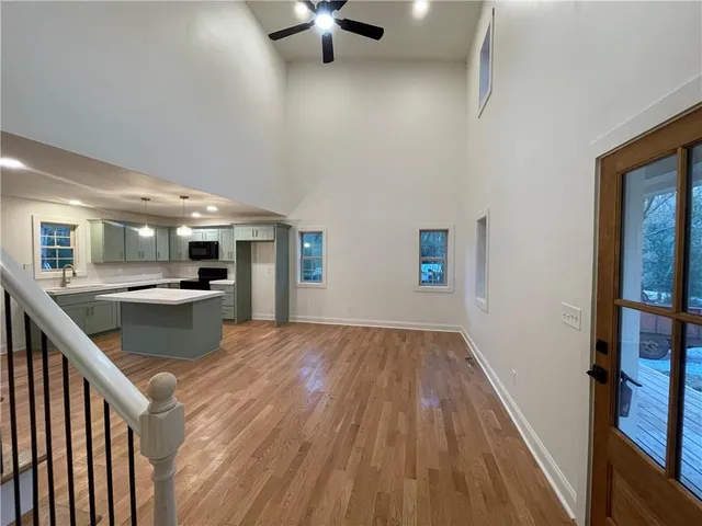 a kitchen with kitchen island white cabinets and stainless steel appliances
