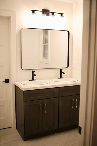 a bathroom with a double vanity sink and mirror