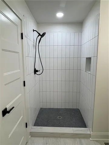a bathroom with a glass shower door