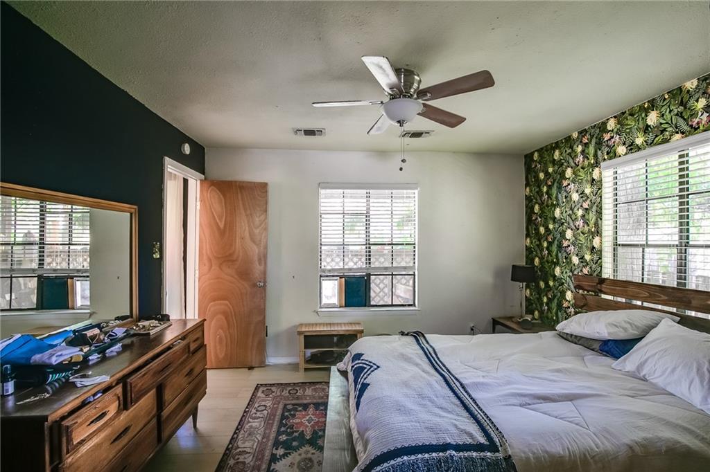 2400 Thornton Road, Unit A Austin, TX 78704 - Photo 8 of 15 a bedroom with a bed and a chandelier