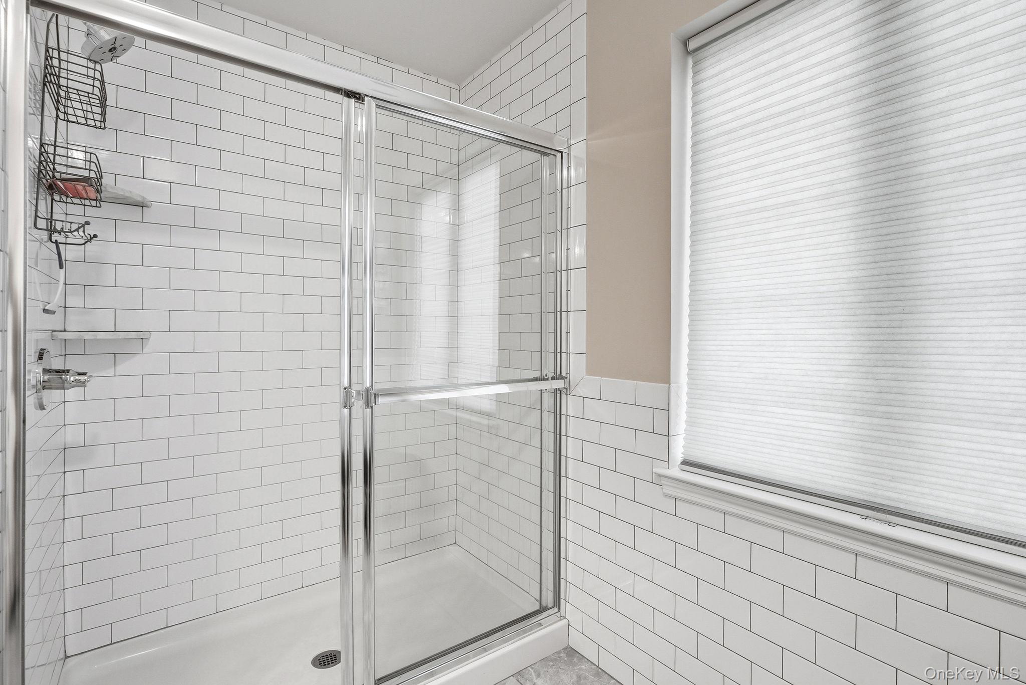 8 Muscoot River Road Granite Springs, NY 10527 - Photo 23 of 40 Primary bathroom featuring shower enclosure with clear glass sliding doors and polished chrome hardware