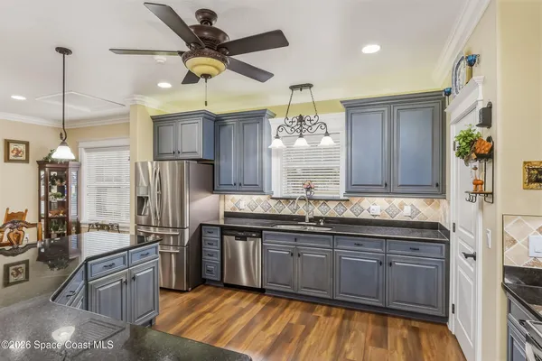 a living room with furniture a rug and a chandelier