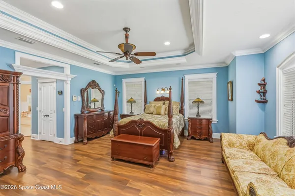 a bedroom with a bed and a chandelier
