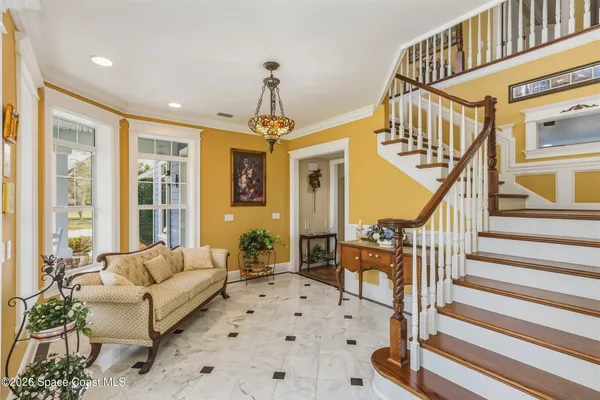 a living room with furniture fireplace and window