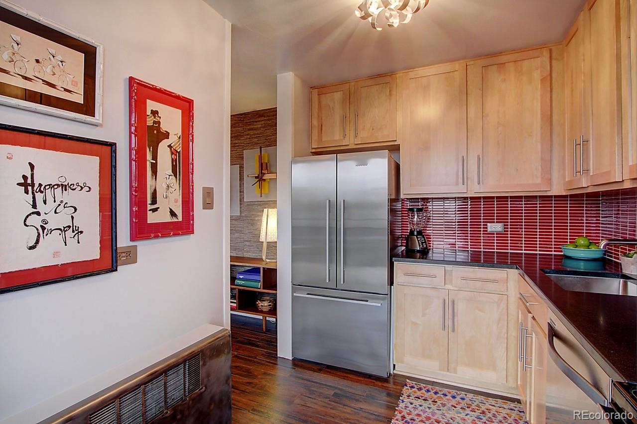 1200 Vine Street, Unit 4B Denver, CO 80206 - Photo 16 of 33 a kitchen with granite countertop stainless steel appliances a refrigerator and a sink