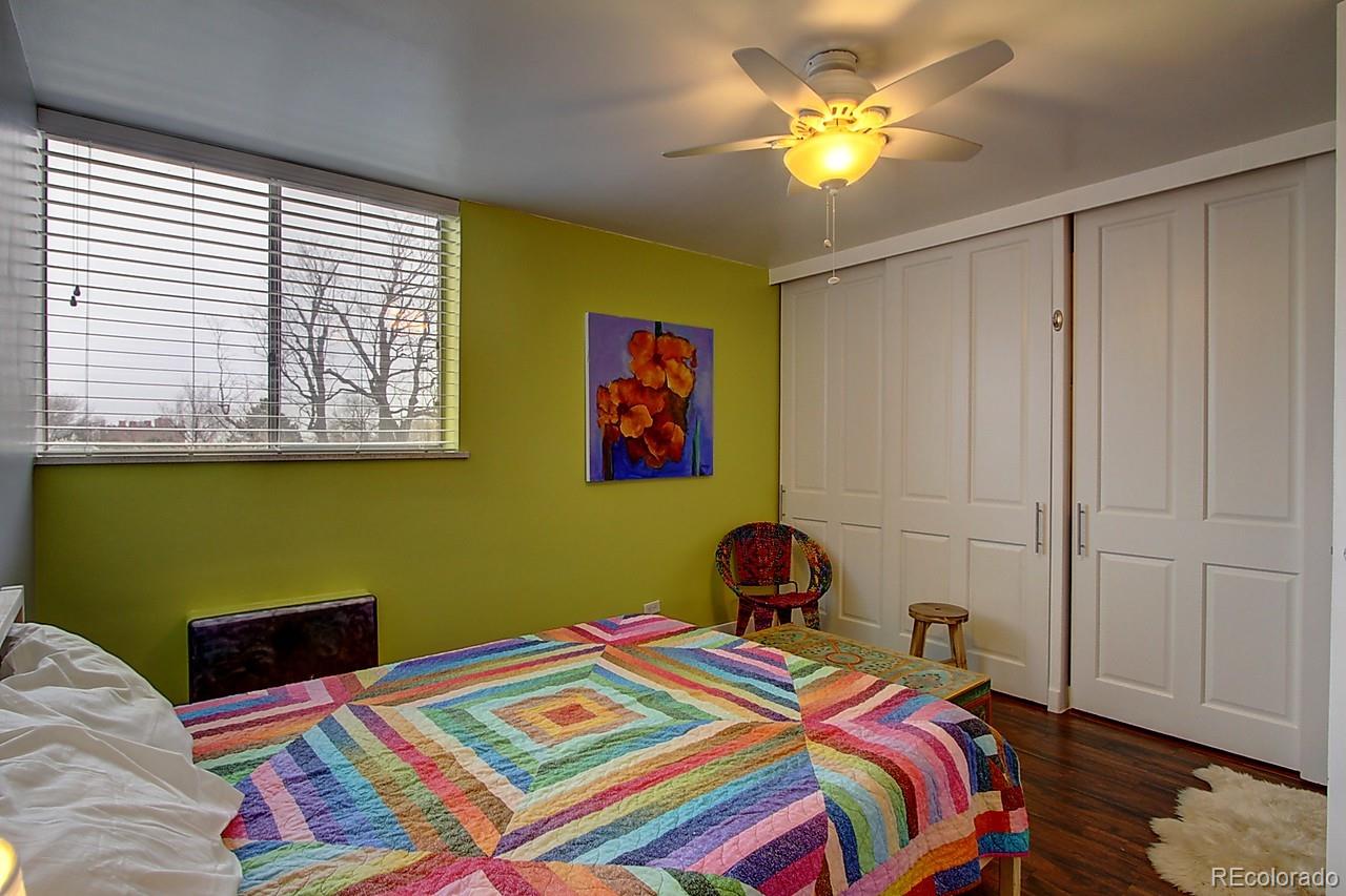 1200 Vine Street, Unit 4B Denver, CO 80206 - Photo 21 of 33 a bedroom with a bed and a chandelier