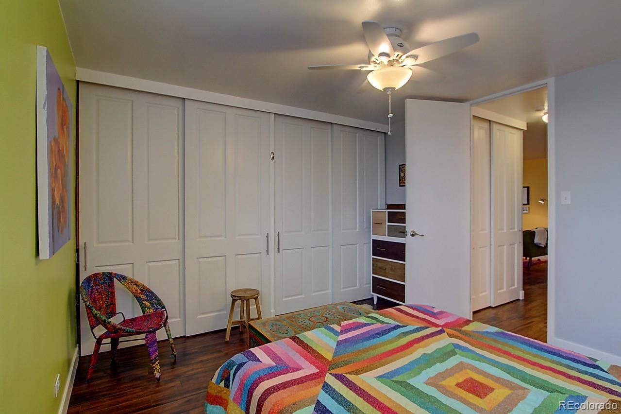 1200 Vine Street, Unit 4B Denver, CO 80206 - Photo 22 of 33 a bedroom with bed and a chandelier