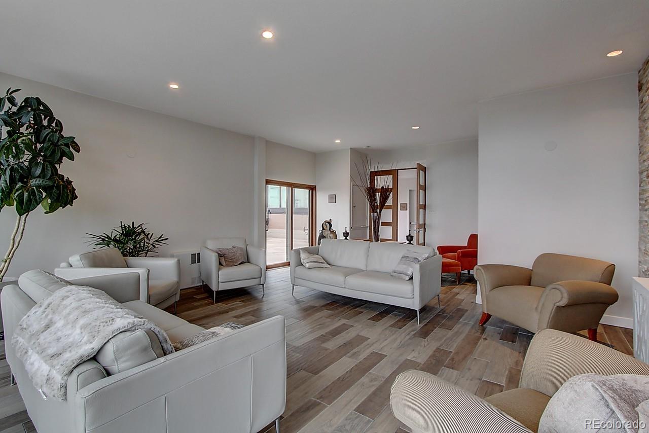 1200 Vine Street, Unit 4B Denver, CO 80206 - Photo 24 of 33 a living room with furniture and a potted plant