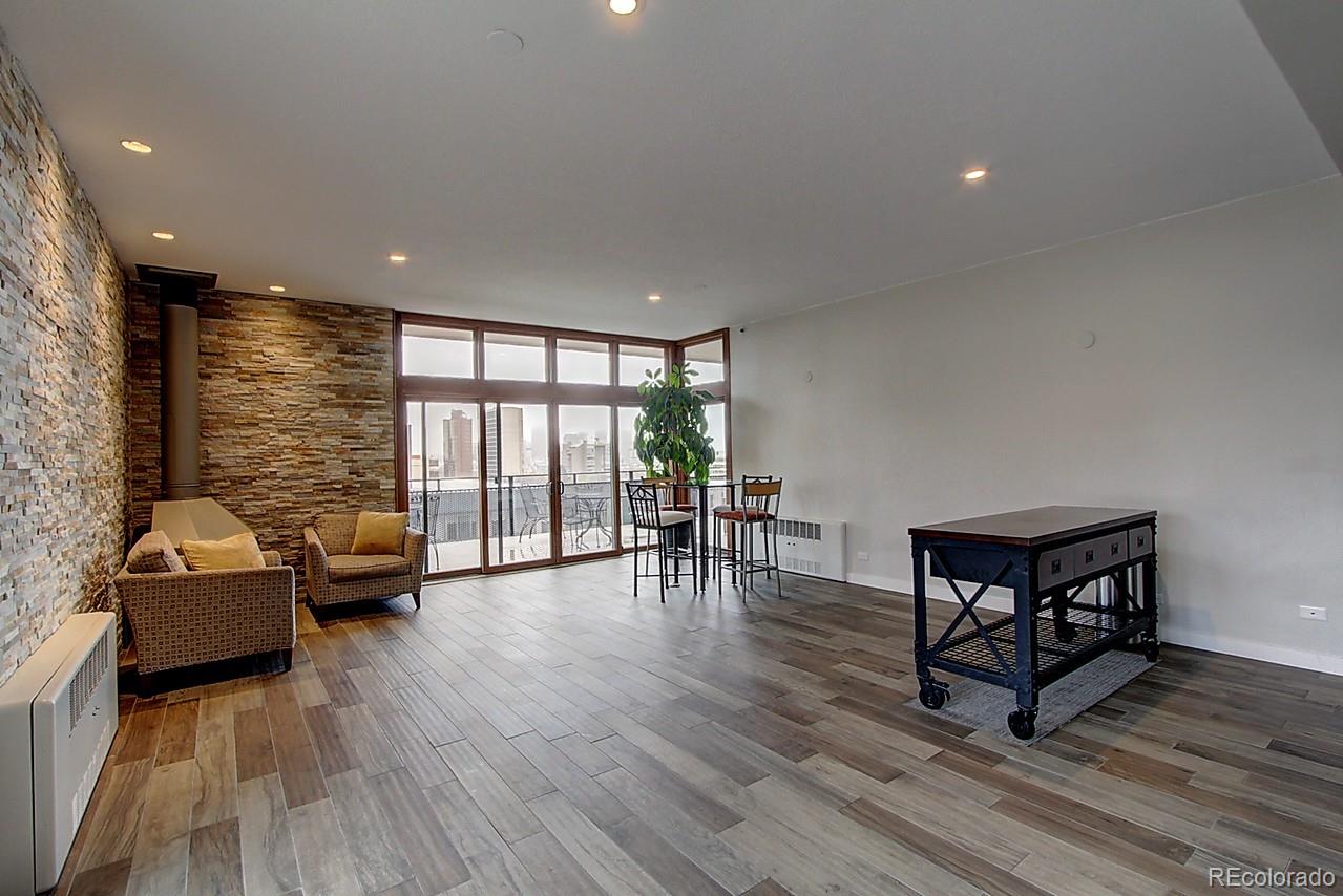1200 Vine Street, Unit 4B Denver, CO 80206 - Photo 28 of 33 a living room with furniture and wooden floor