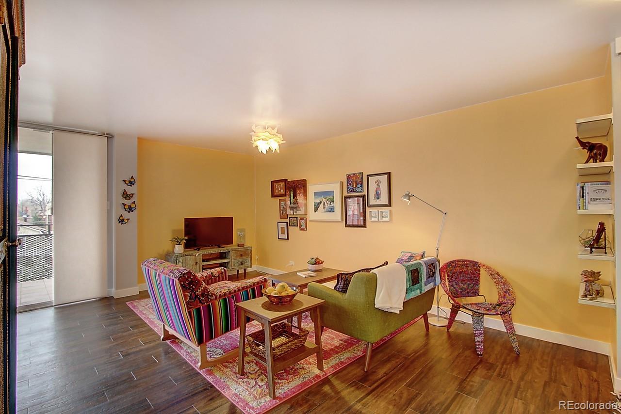 1200 Vine Street, Unit 4B Denver, CO 80206 - Photo 3 of 33 a view of a dining room with furniture and wooden floor
