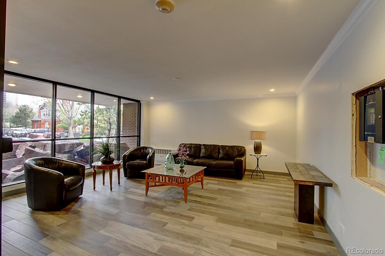 1200 Vine Street, Unit 4B Denver, CO 80206 - Photo 31 of 33 a living room with furniture and a flat screen tv