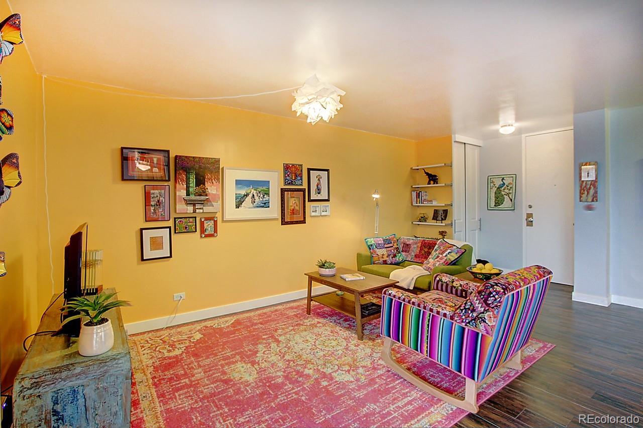 1200 Vine Street, Unit 4B Denver, CO 80206 - Photo 4 of 33 a living room with furniture and a flat screen tv