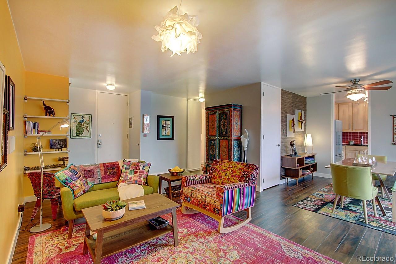 1200 Vine Street, Unit 4B Denver, CO 80206 - Photo 5 of 33 a living room with furniture a rug and a chandelier